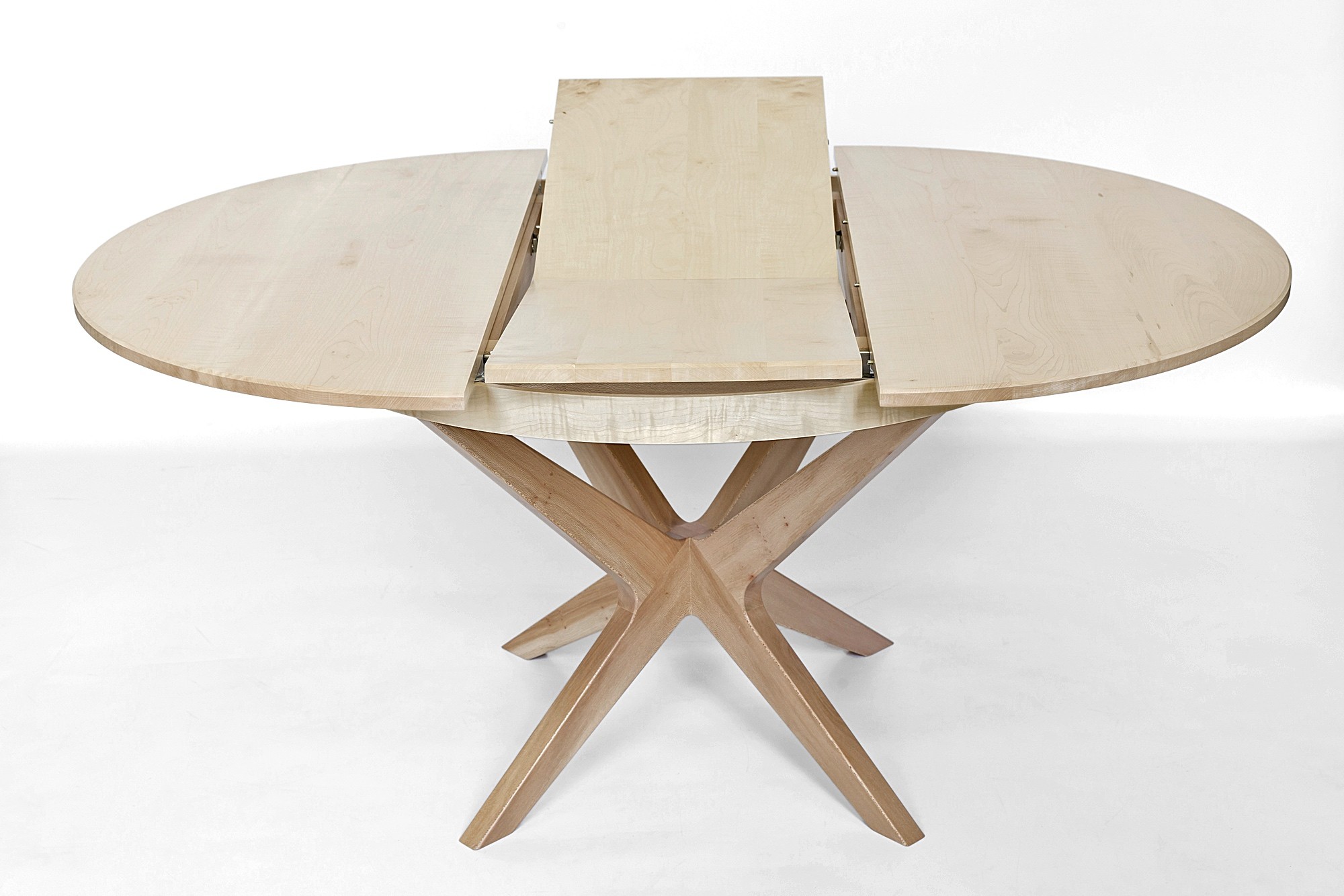Extending dining table showing butterfly leaf extension