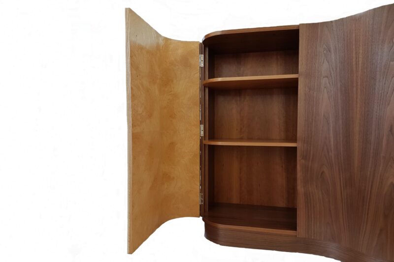 Contemporary hall cabinet with curved door open displaying cherry shelves inside