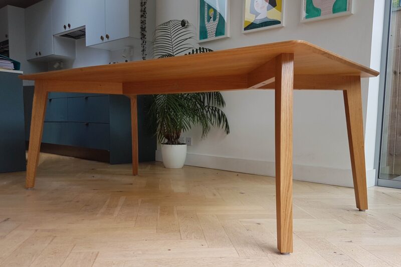 Showing Y-shaped under-frame of bespoke oak dining table