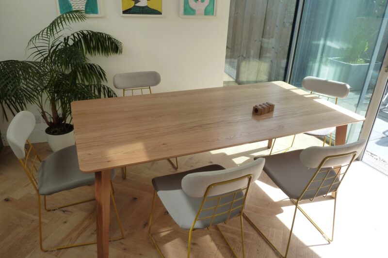 Large oak dining table with chairs set around