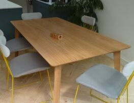 Scandinavian style oak dining table with chairs around