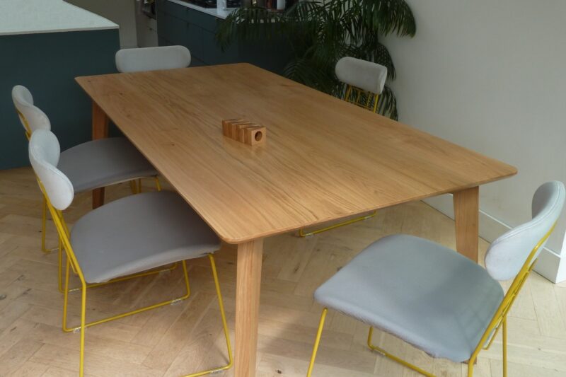 Scandinavian style oak dining table with chairs around