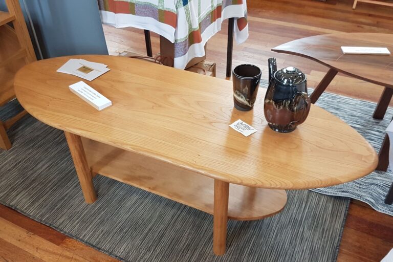Elliptical shaped coffee table with an undershelf, made of English Oak