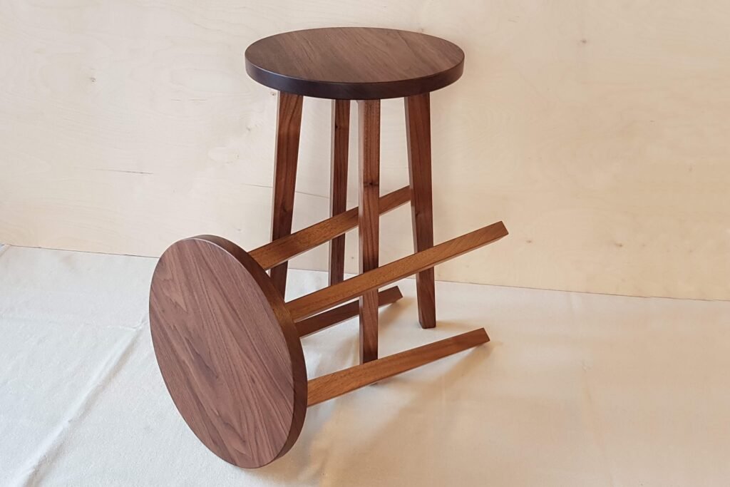 Two walnut side tables one on it's side and one standing up