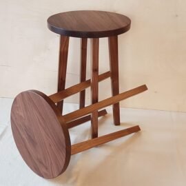 Two walnut side tables one on it's side and one standing up